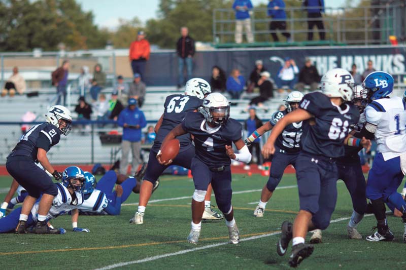 Students running on a football field